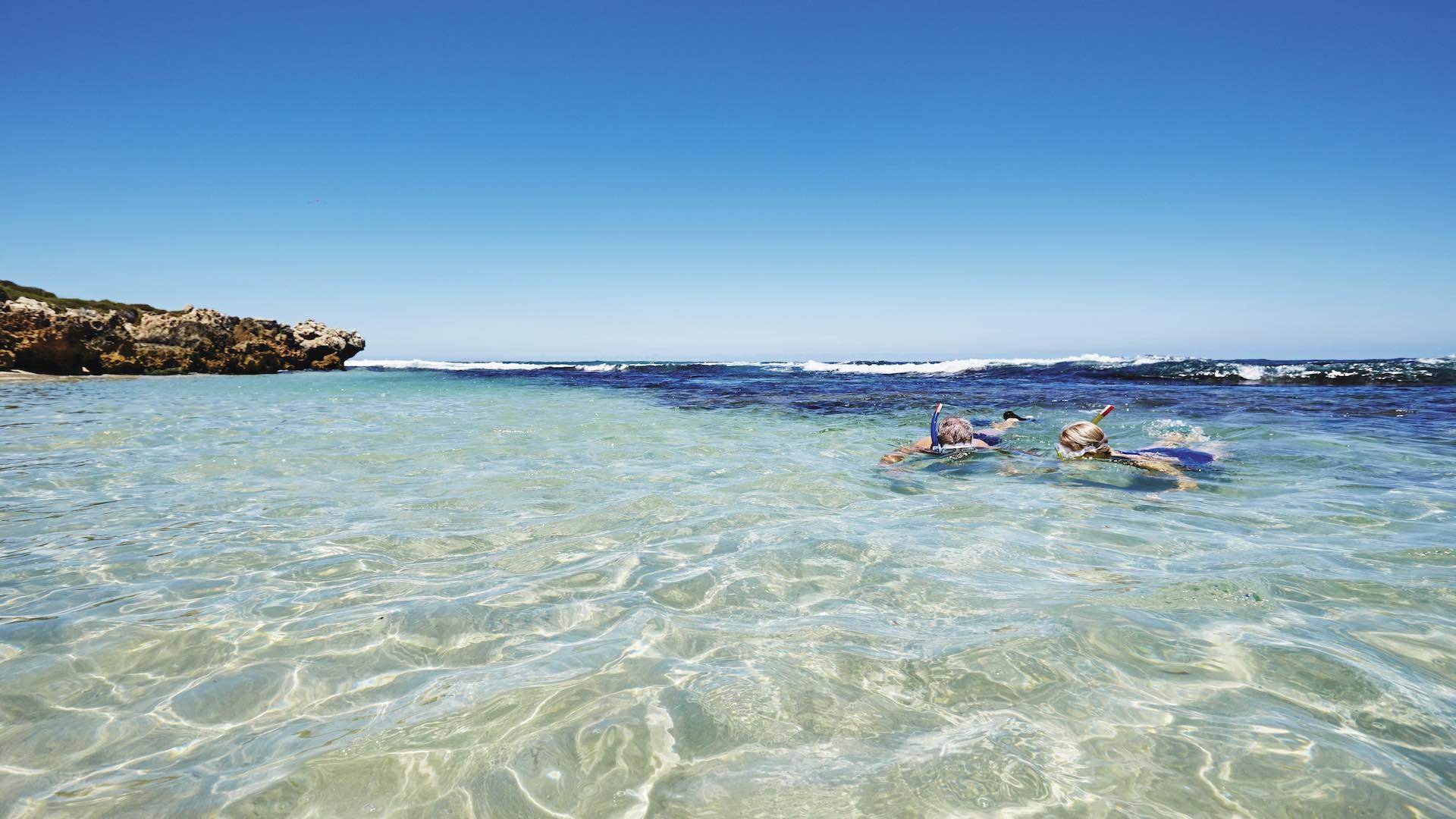 Couple snorkelling at Mettams pool, near Trigg beach.